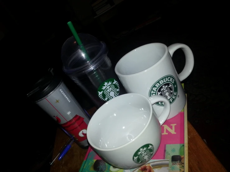 coffee cups and a magazine are on a table