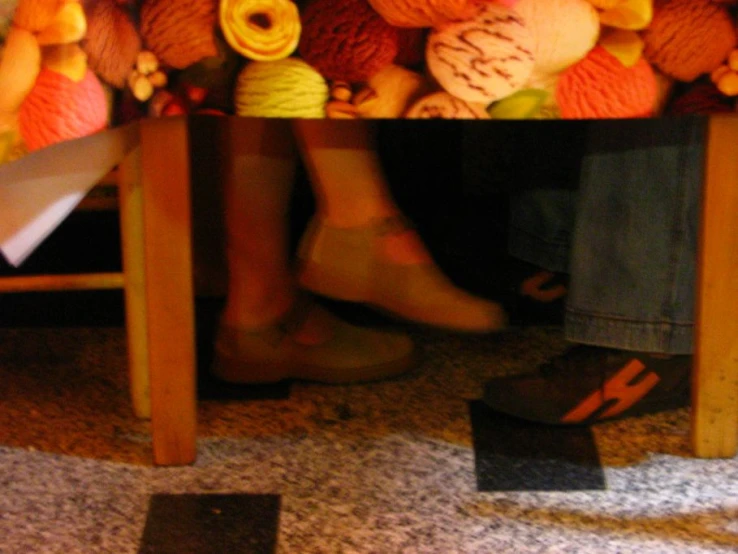 a group of people standing under a table