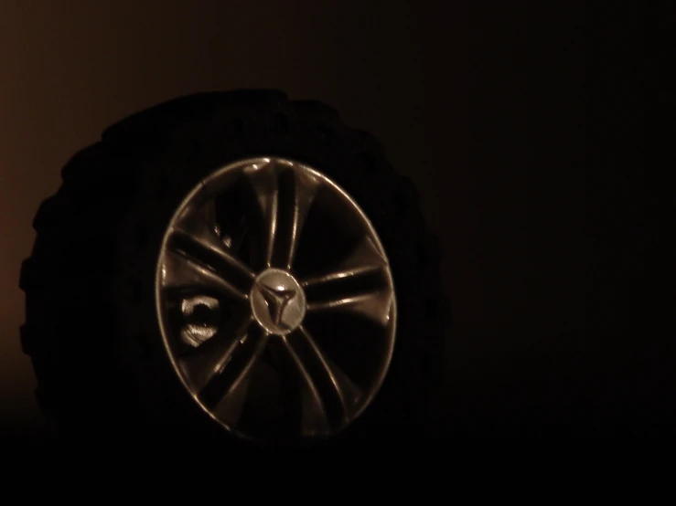 a wheel and tire on a dark background