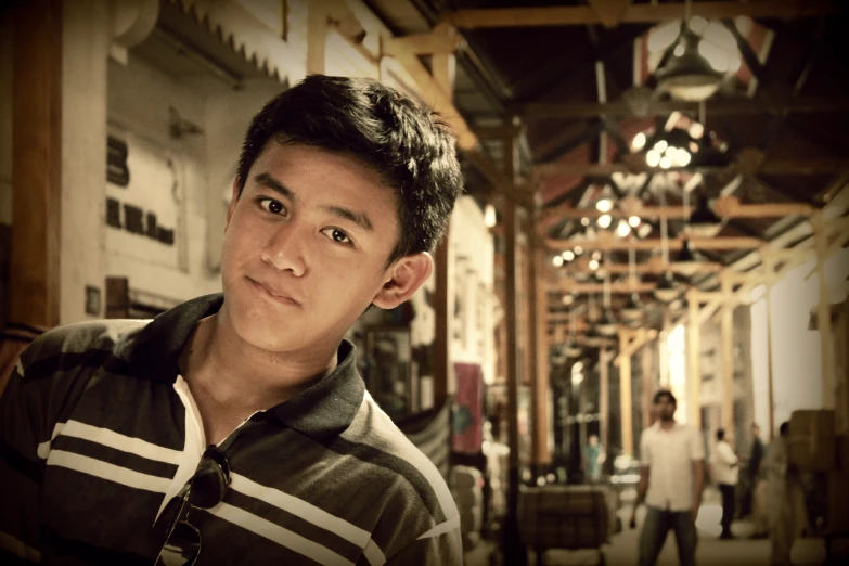 a young man poses for a po in an unfinished building