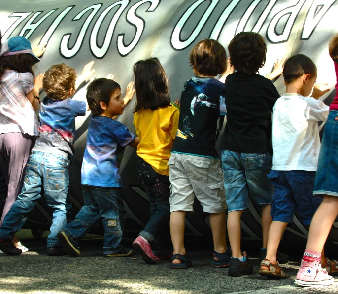 there are many children climbing the wall together