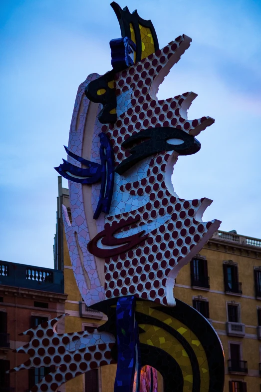 a very large neon sculpture outside a building