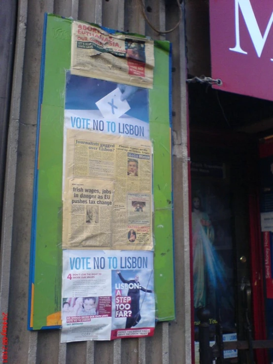 a sign in front of a store is taped to the side of a building