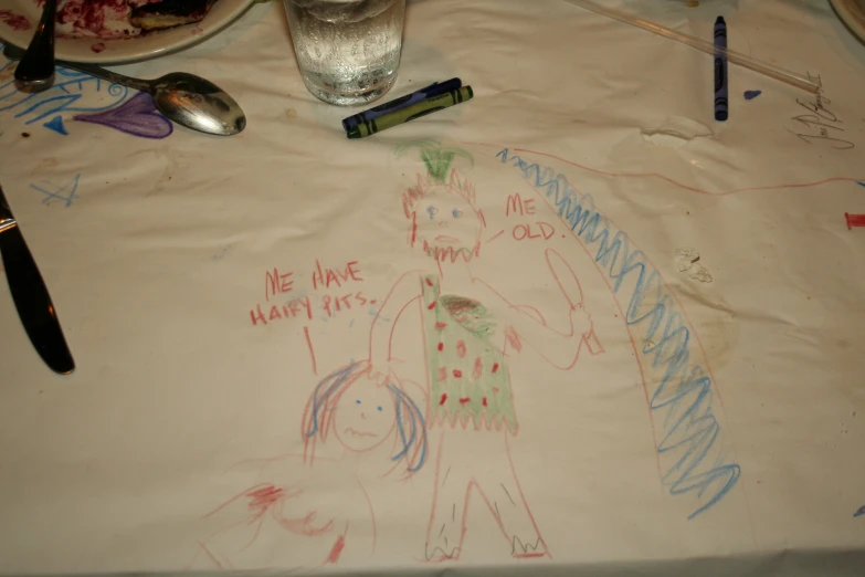 two children's drawings on a table that are dirty