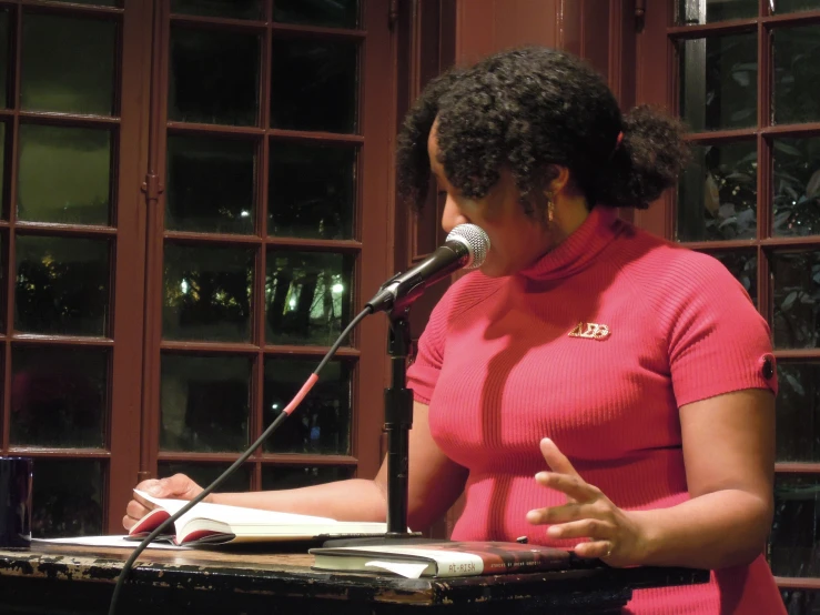 a woman standing in front of a microphone