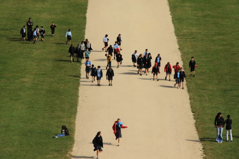 a group of people walking down a road