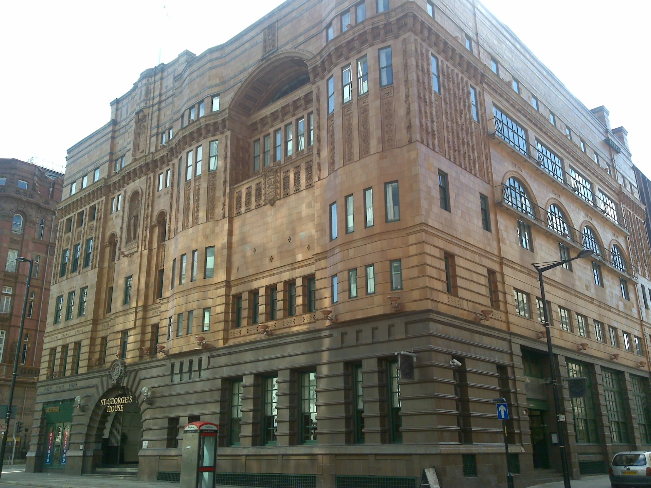 a building with large windows and a clock tower above it