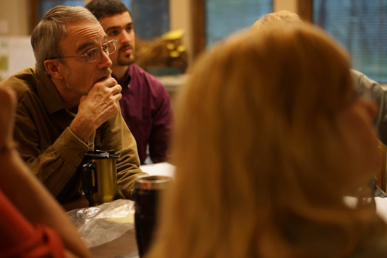 a group of people in a room watching soing