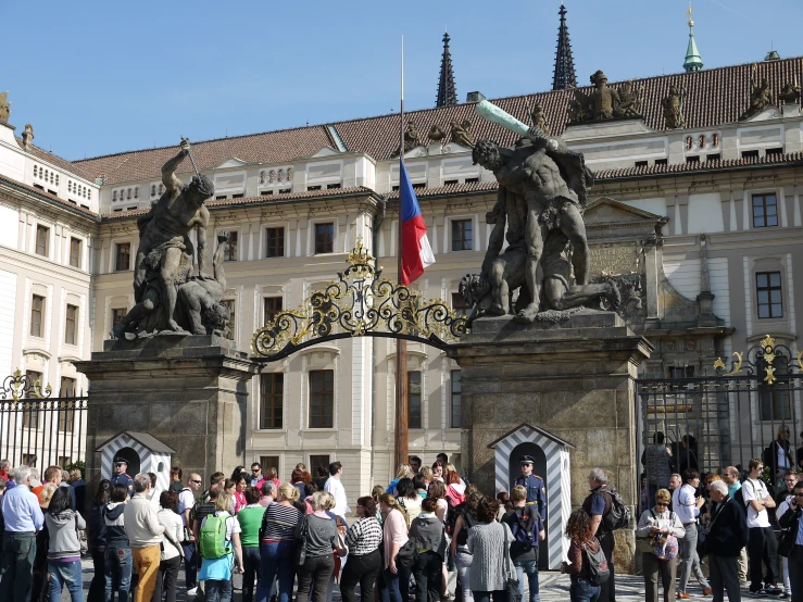 a group of people standing outside a big building