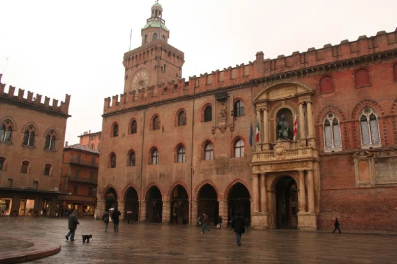 people walking on the square in front of a castle building