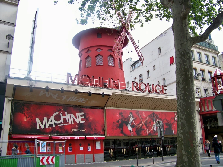 a red clock tower that is surrounded by buildings