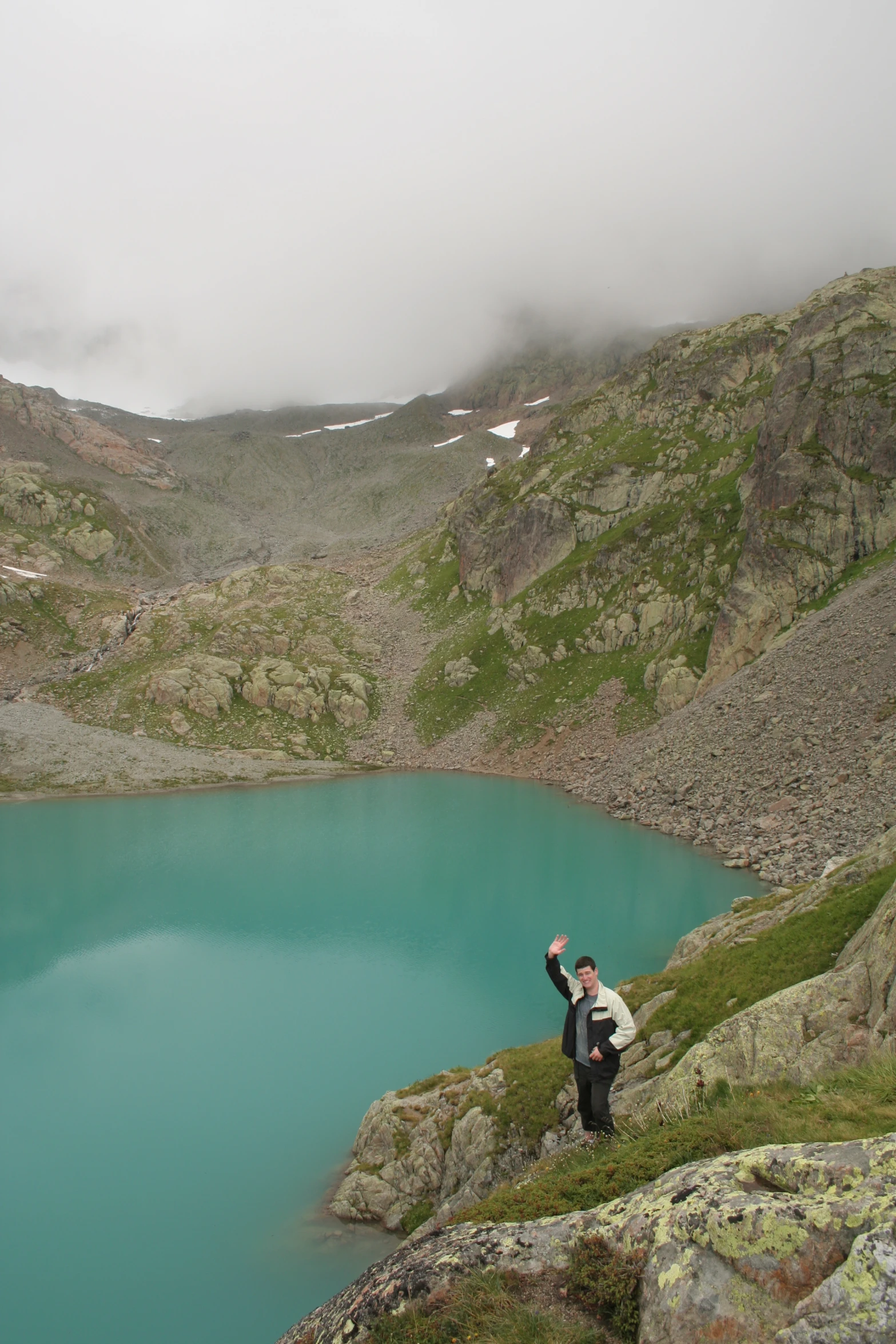 a man and his dog hang on the edge of a cliff