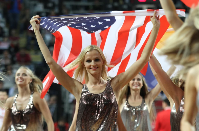 two women holding an american flag in their hands