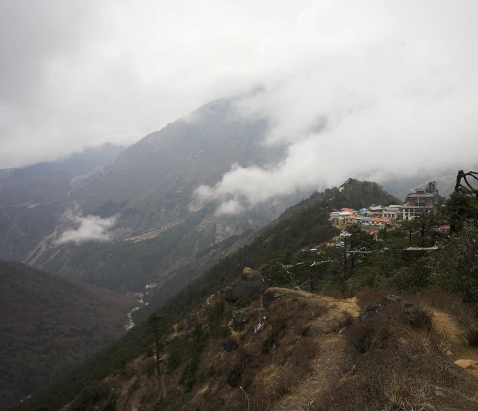 clouds fly overhead over some green hills