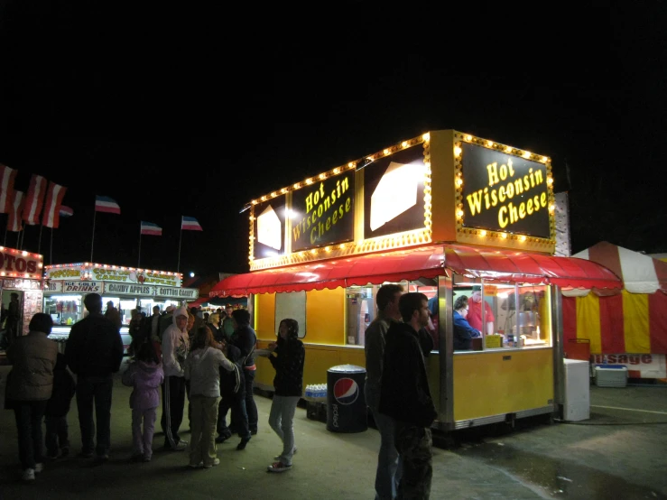 several people are standing around a food truck