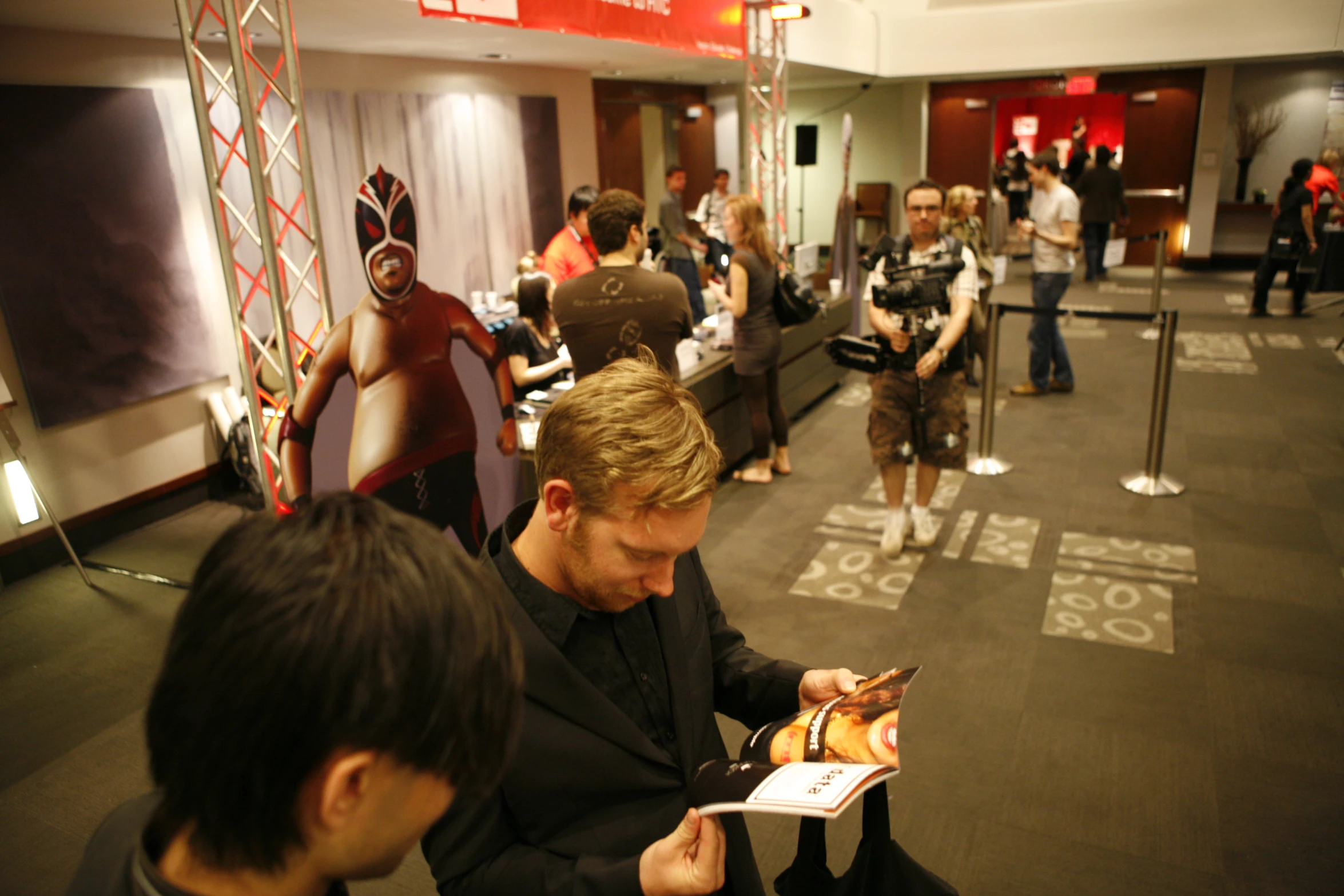 a man at an exhibit looking at his phone