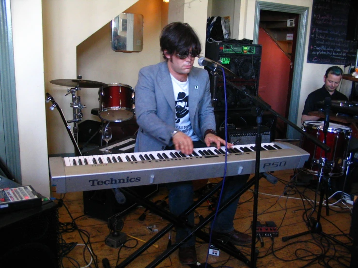 a person sitting at a piano playing a musical instrument