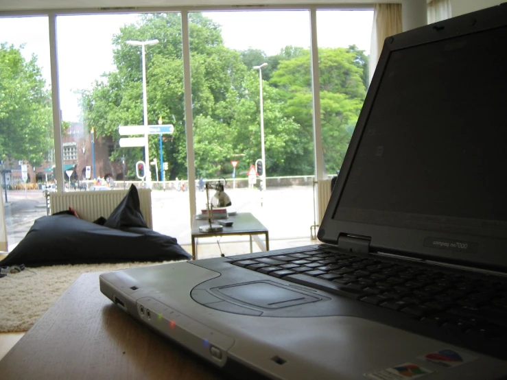 a laptop computer sitting on top of a wooden table