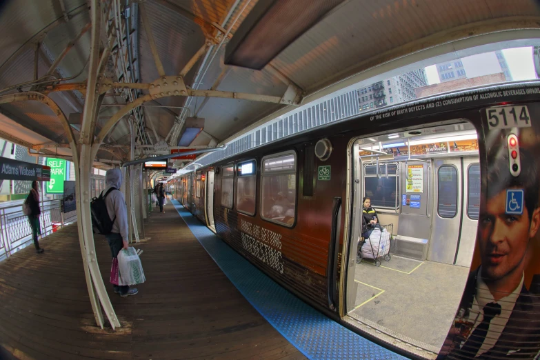 the rear view mirror of a passenger train at a train station