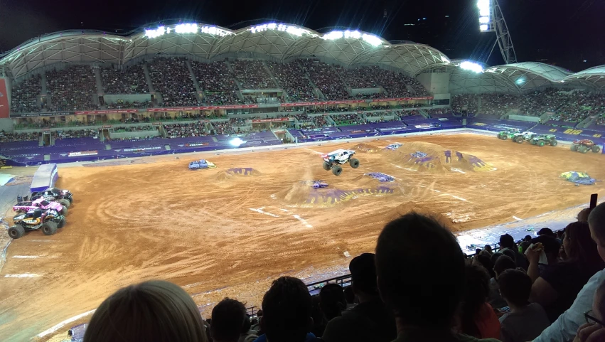 a dirt bike race going on a track in an arena