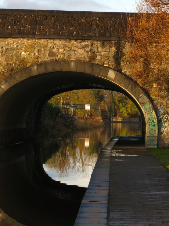 a brick tunnel is shown on a waterway