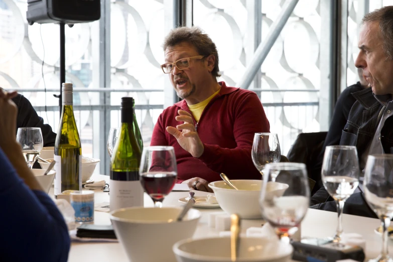 man speaks to a group of wine tasting friends