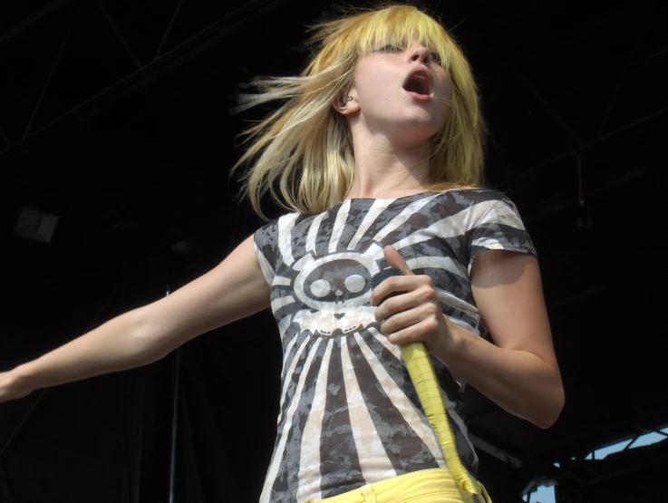 a person wearing a yellow skirt with a yellow guitar string on her finger