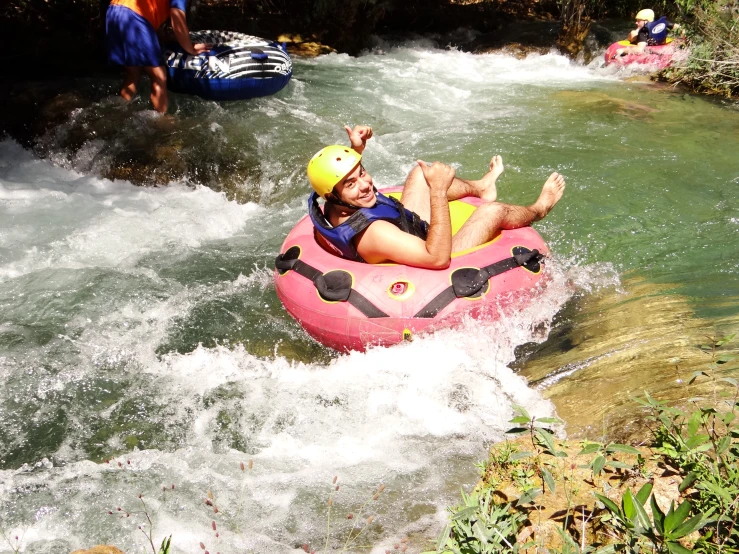 a person in an inflatable raft on a rushing river