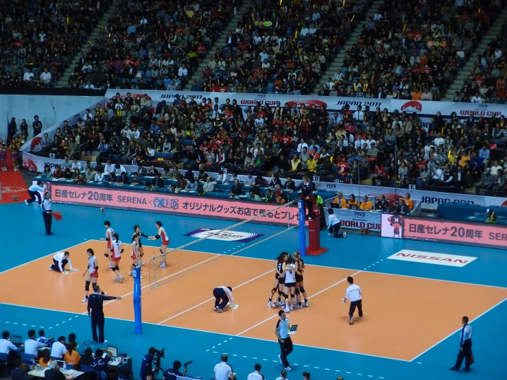 a large crowd is watching a game on a court