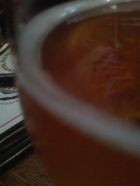 a beverage glass full of beverage sitting on top of a table