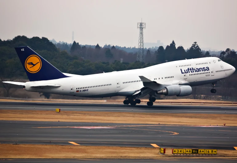 a large plane is moving along the runway