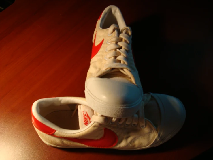 a pair of white, red and black nike sneakers