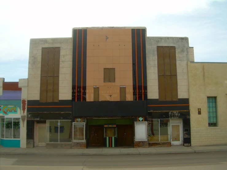 a very tall brown building sitting on the side of a street