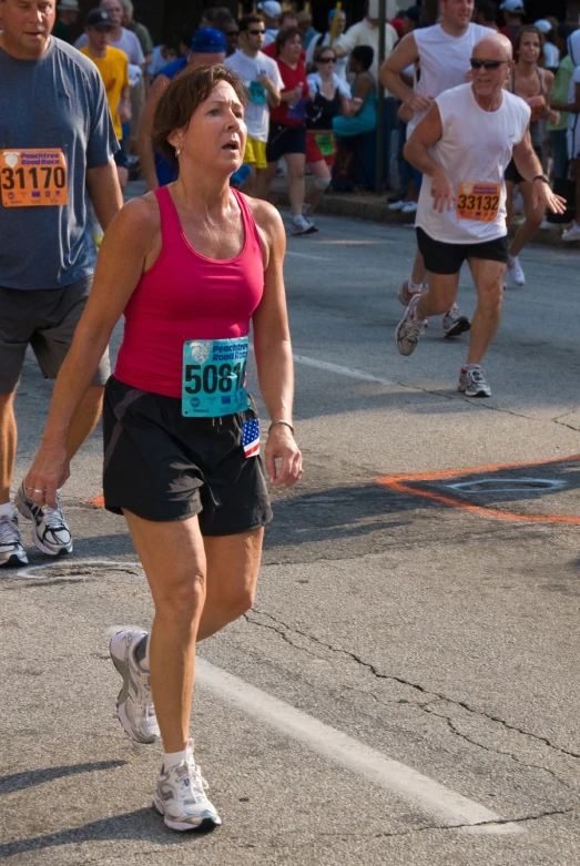 a lady is in the street running with another person walking