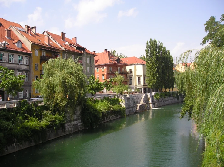 a small river near some very old town houses