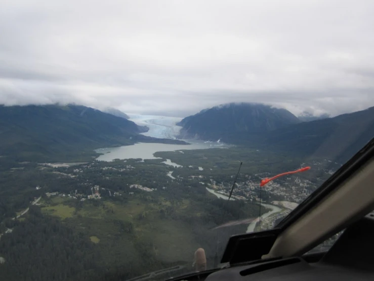 a view from an airplane of the mountains and water