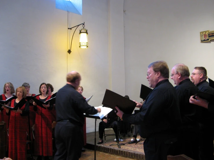 a band of people standing around with musical instruments