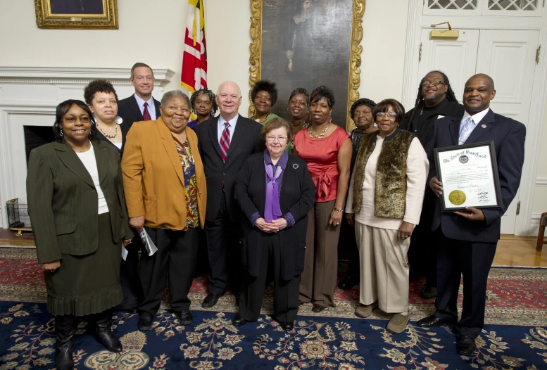 there is a group of people in a room posing for a picture