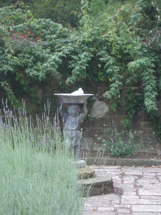 there is a large birdbath sitting by some steps