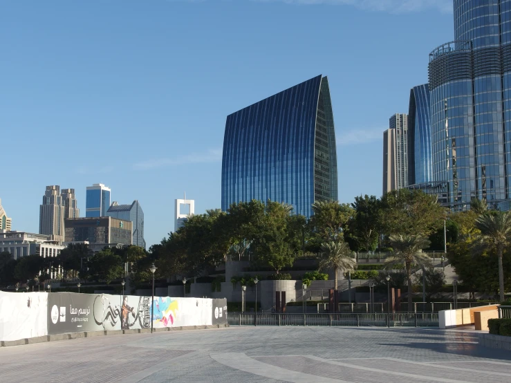 a city street lined with parked vehicles and large buildings