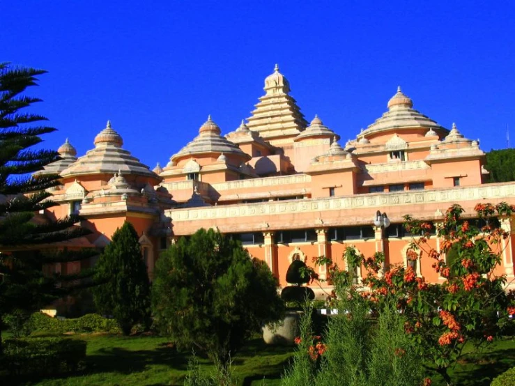 a pink colored building with lots of turrets sitting on top of it