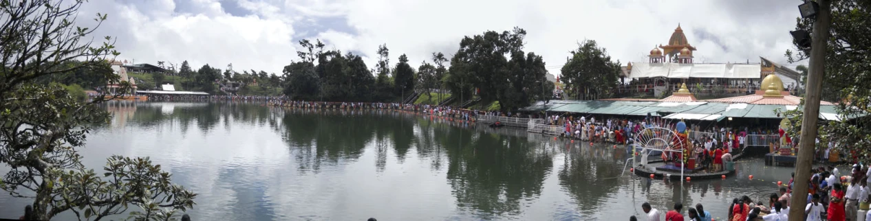 a lake full of people near a pavilion