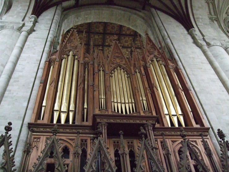 a large organ mounted in a wall next to other buildings