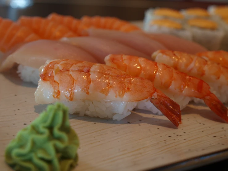 sushi platter with different types of shrimp and broccoli