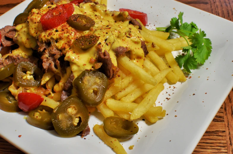 a white plate topped with lots of french fries and veggies