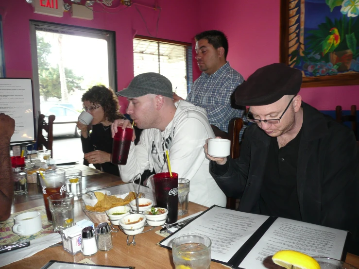 a group of men sitting around a table