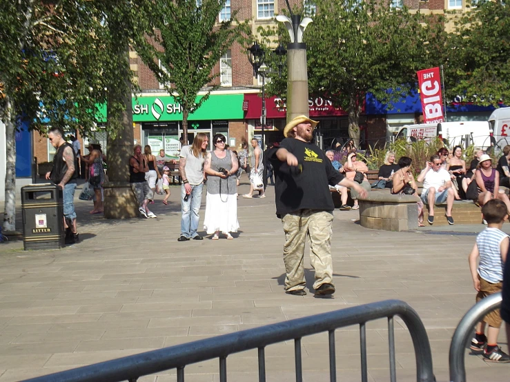 a man standing on the street with his arms spread wide