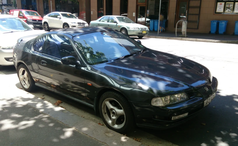 the car is parked in front of the blue building