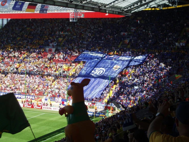 the giant balloon dog is performing a show at a soccer match