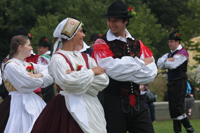 a woman standing next to a man dressed up